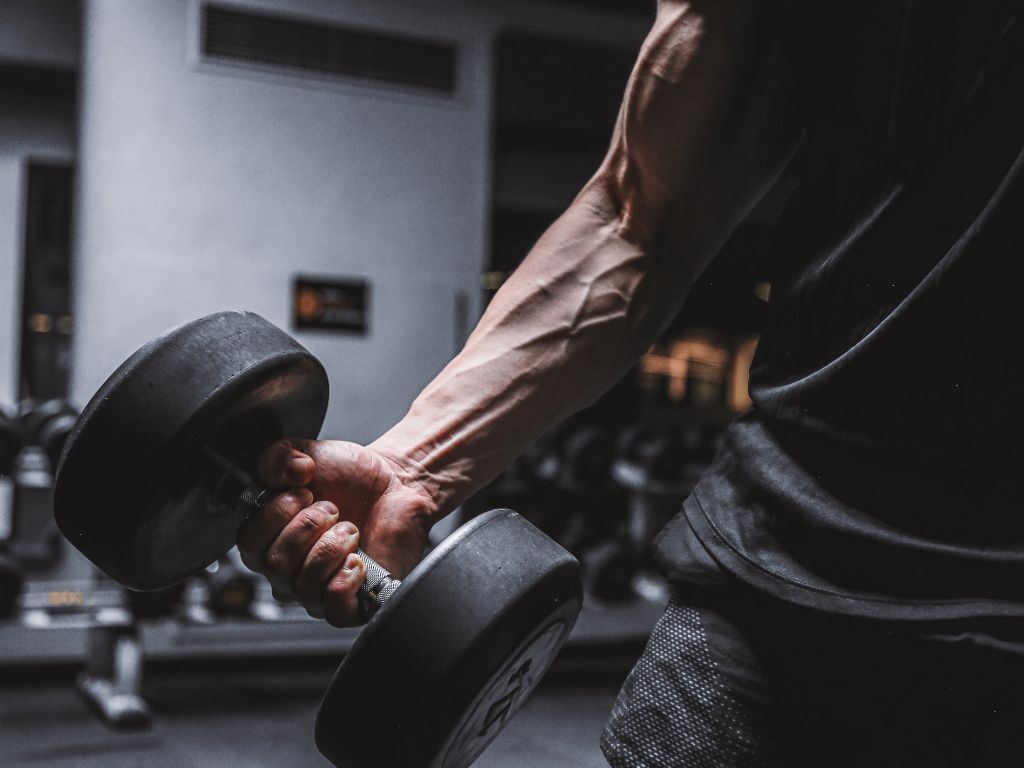 A man's arm lifting a heavy weight