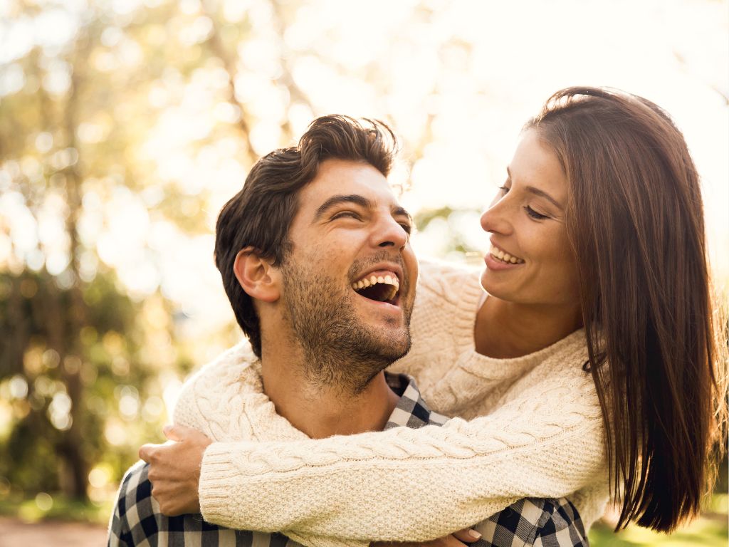 A couple smiling in the sun